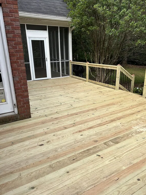 Composite deck boards with a white rail and black metal balusters