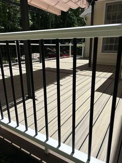 Deck railing detail against the tree line