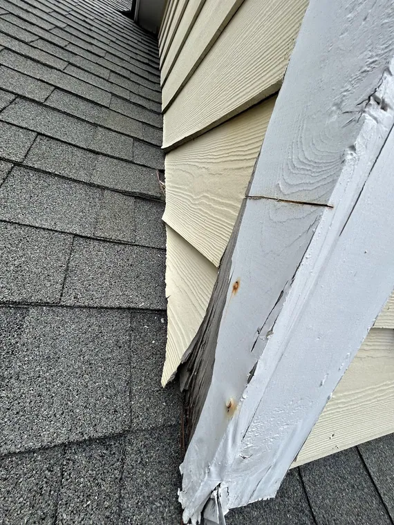 Storm damaged roof shingles before repair