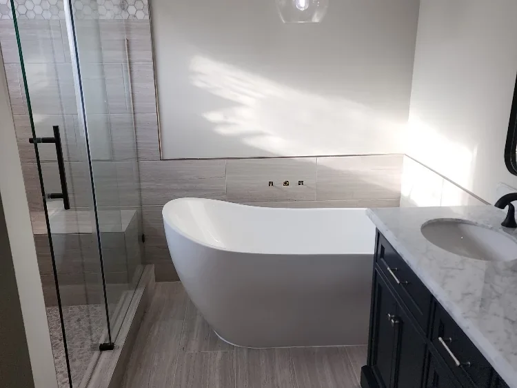 Remodelled bathroom with a freestanding tub, glass shower and vanity