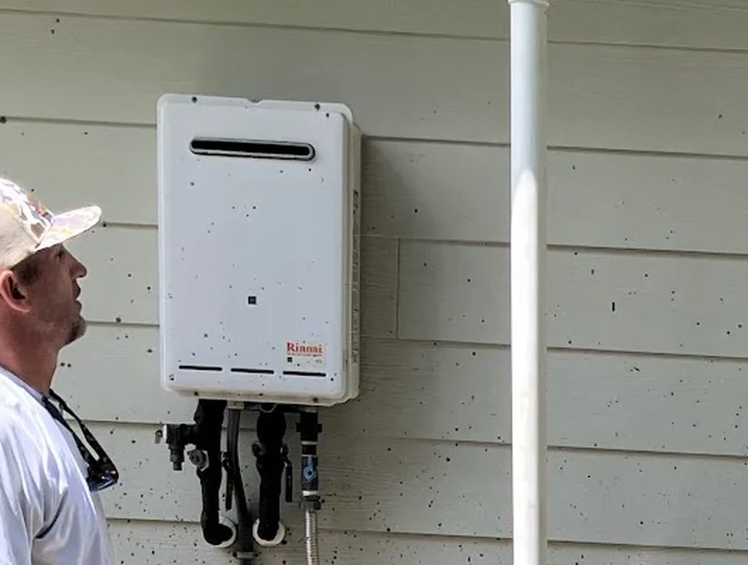 Wall mounted tankless water heater installed on a home exterior